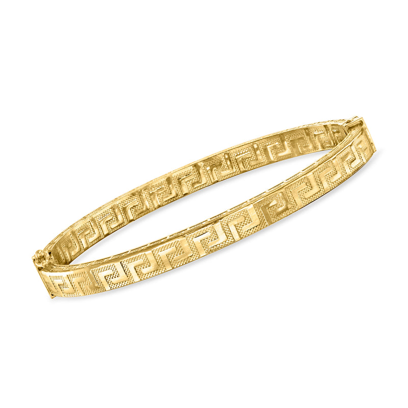 Gold-tone bangle bracelet with Greek key pattern and hinged closure