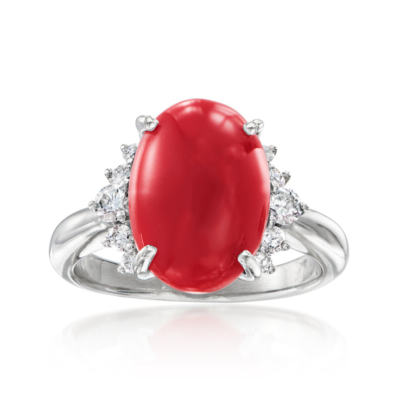 Platinum ring with oval red coral center and small diamond side stones