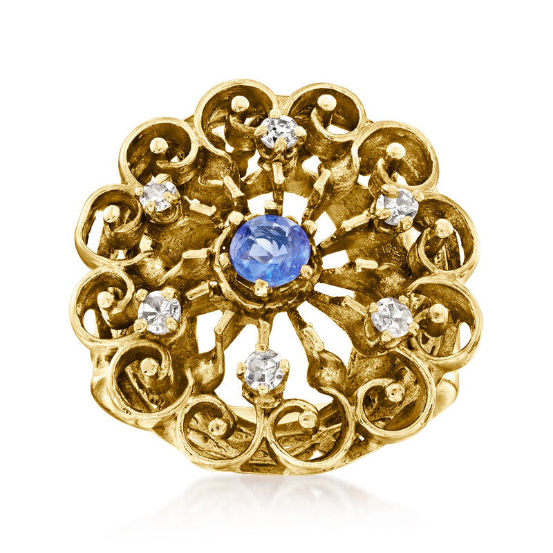 14kt yellow gold scrollwork ring with oval blue sapphire center and diamond accents