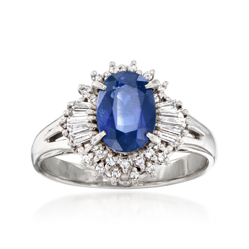 Platinum ring with oval blue sapphire center, surrounded by diamond halos and accents