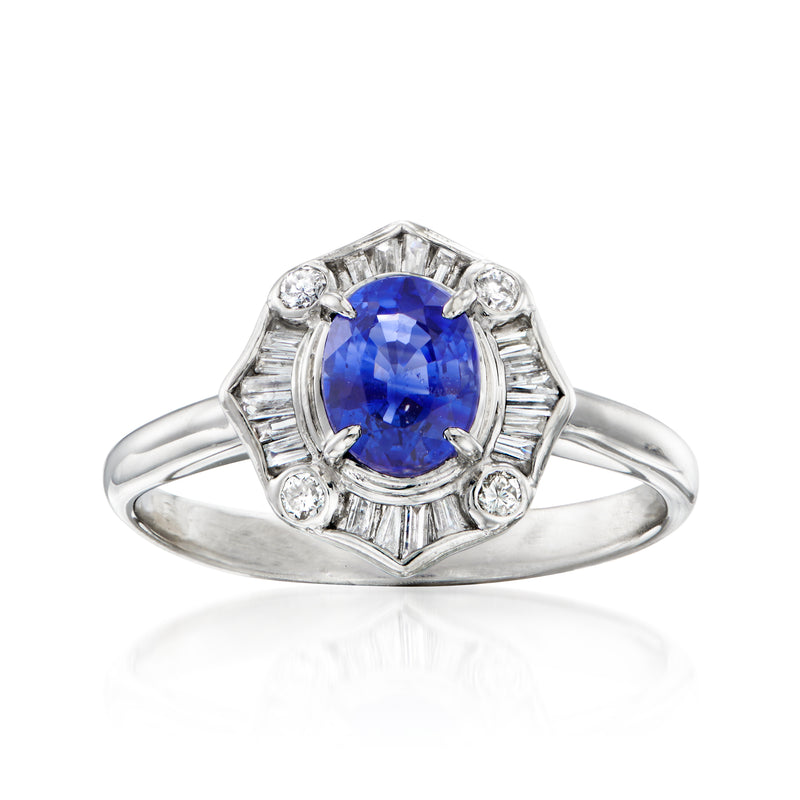 Platinum ring with oval blue sapphire and diamond halo accents, split prongs