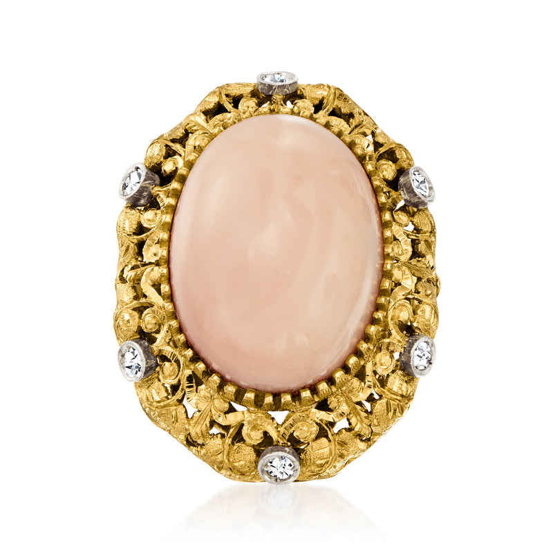 Oval pale pink coral cabochon ring in yellow gold with diamond halo and side stones