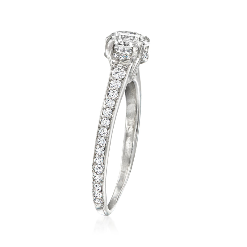 Platinum ring with prong-set round diamond center and pave band