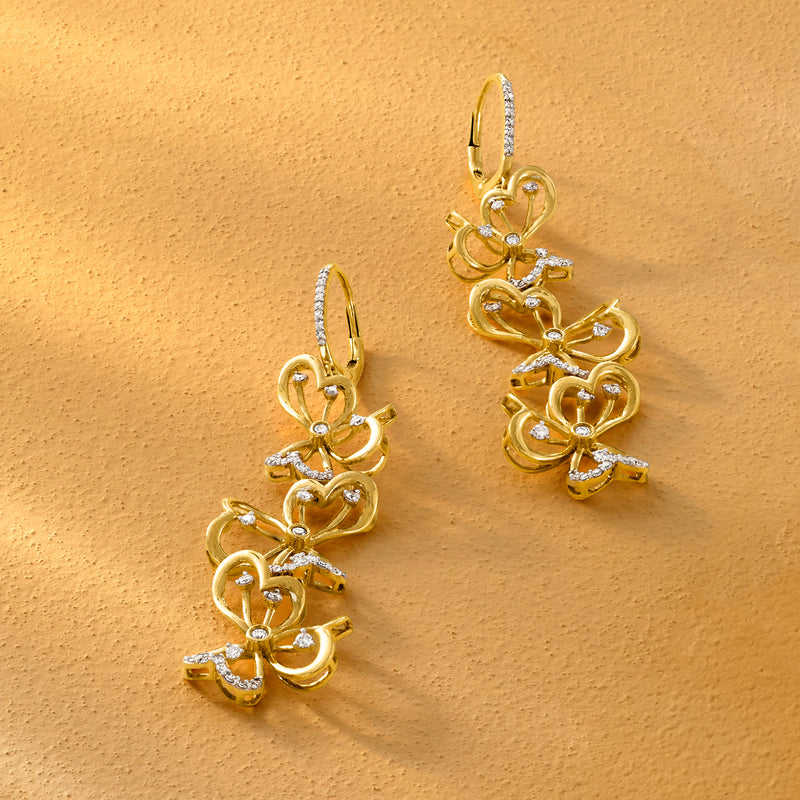 Close-up gold vermeil floral drop earrings with diamond accents and leverback hooks