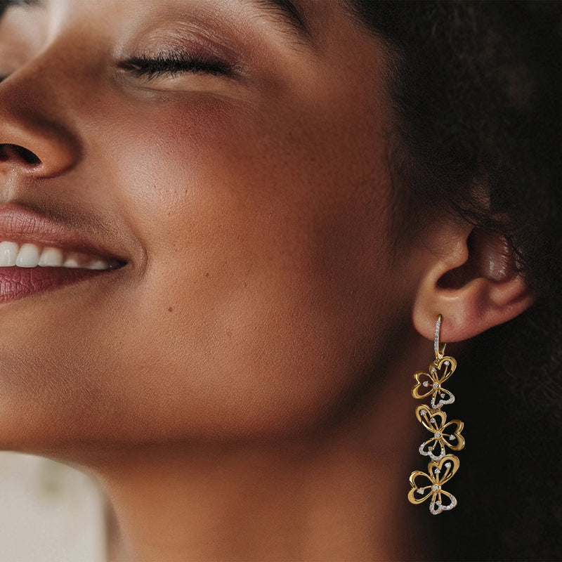 Gold vermeil floral drop earrings with diamond accents, dangling clover motifs on leverback