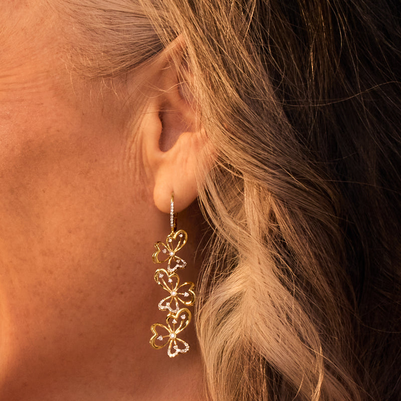 Gold vermeil floral drop earrings with diamond accents, slim clover dangles on leverback