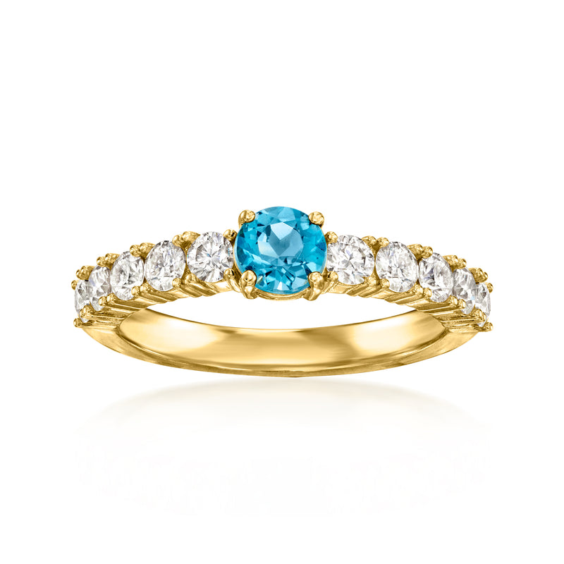 18kt gold over sterling ring with round blue topaz center and clear moissanite accents
