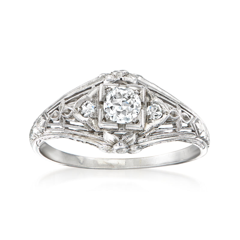 Vintage diamond filigree ring in 18kt white gold with round center stone and side diamonds