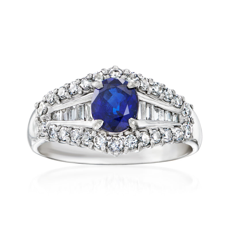 Platinum ring with blue center gemstone and diamond halo and side baguette accents