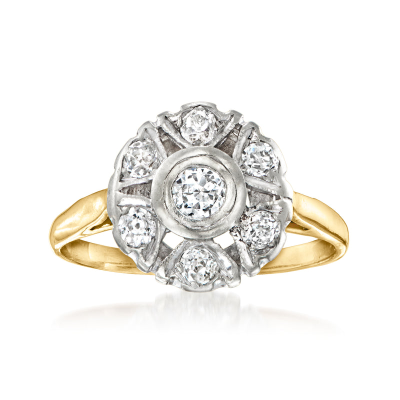 Two-tone gold diamond flower ring with round center stone and halo of small diamonds