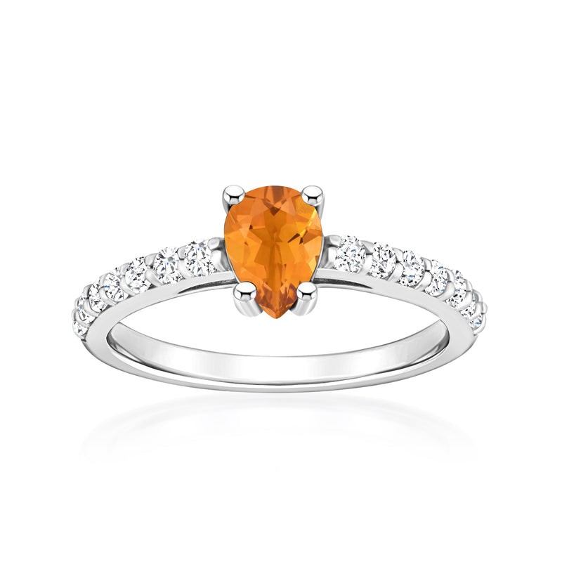 White gold ring with oval orange citrine center and round diamond side accents