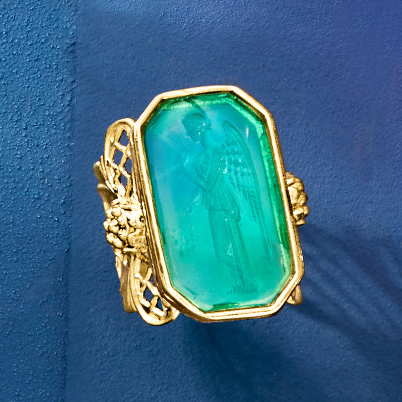 Turquoise glass angel ring with gold-tone filigree setting, angled side view