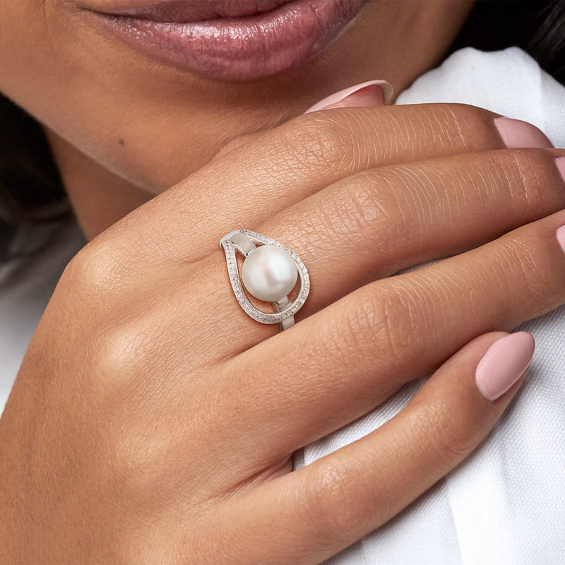 Sterling silver pearl ring with diamond-trimmed openwork setting, worn on hand