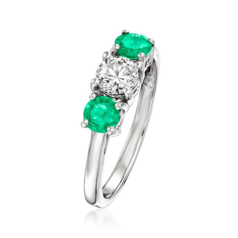 14kt white gold ring angled view with round lab-grown diamond and two emeralds