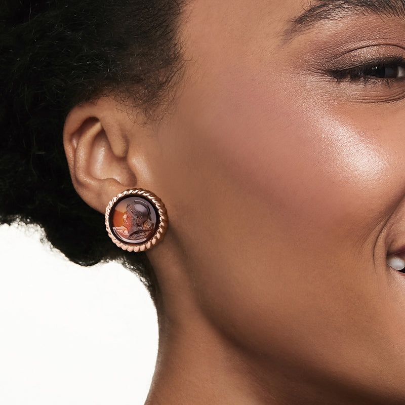 Round carnelian cameo clip-on earring on ear, rope bezel in yellow gold