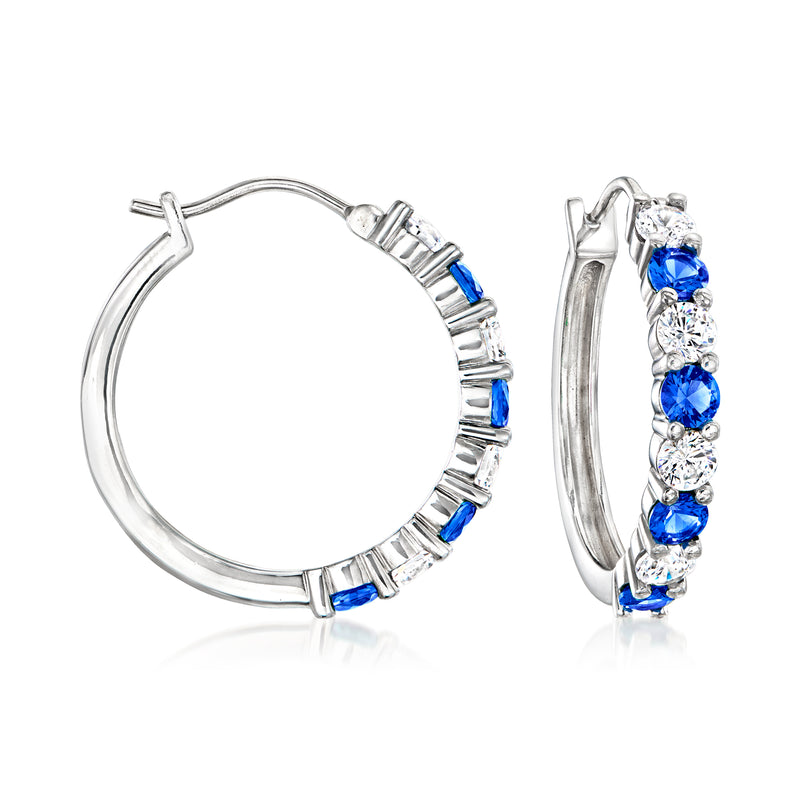 Sterling silver hoop earrings with blue and clear round stones along the front