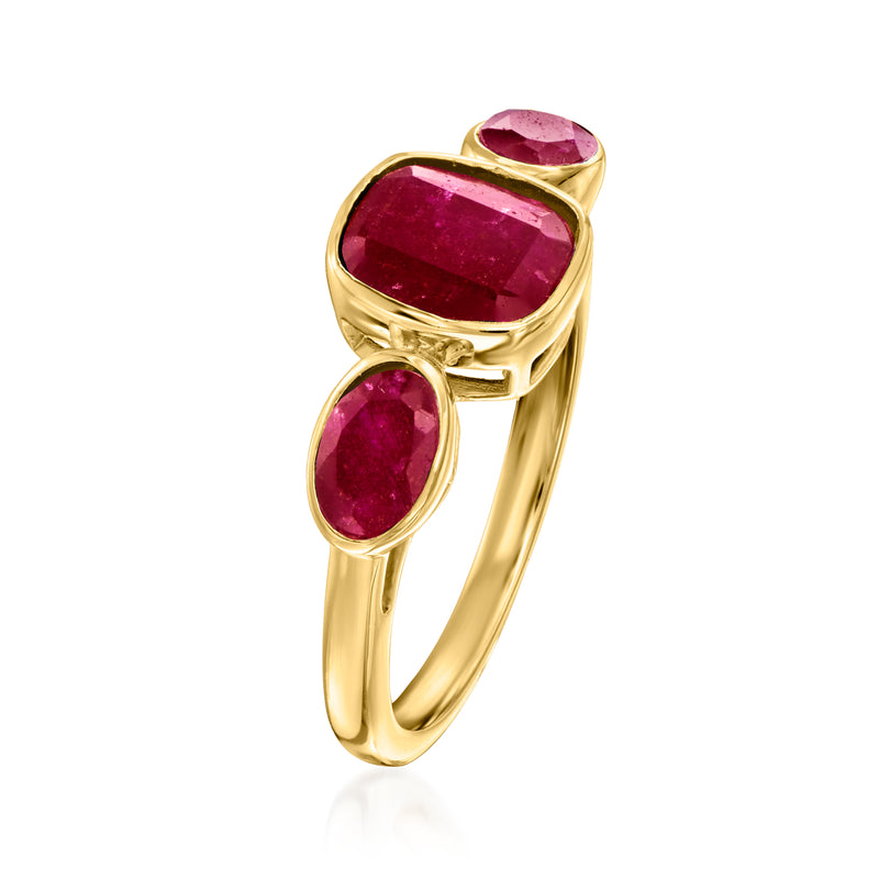 Three-stone ruby ring with large oval center ruby and two side rubies, gold setting