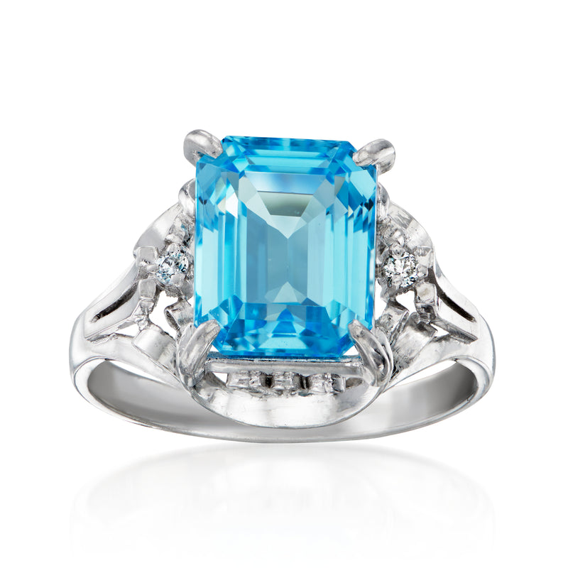 Platinum ring with large sky blue topaz, emerald-cut center and small diamond accents