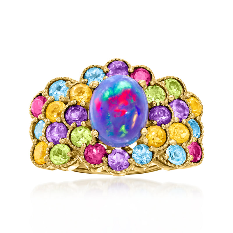 Multi-gemstone ring with oval opal center and round purple, blue, and yellow stones in gold.