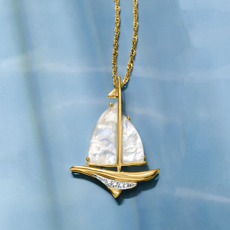 Sailboat pendant necklace with mother-of-pearl sail, gold finish, and diamond trim