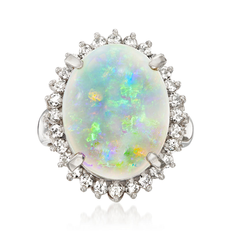 Platinum ring with oval iridescent opal cabochon and diamond halo