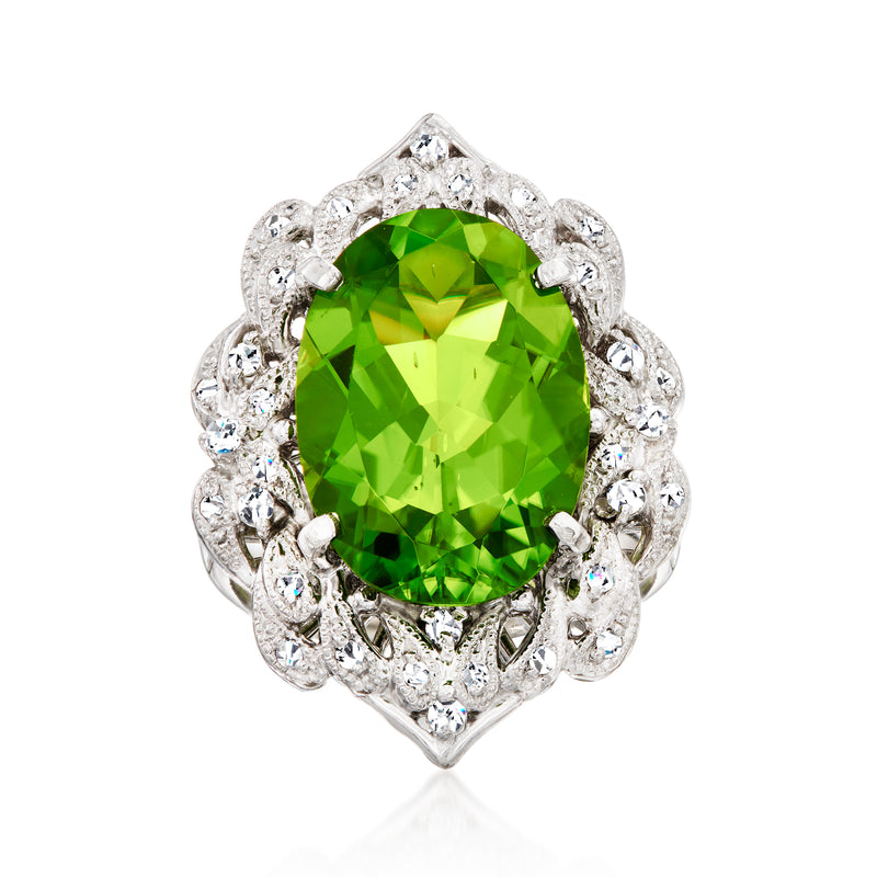 Platinum cocktail ring with oval green peridot center and diamond halo cluster