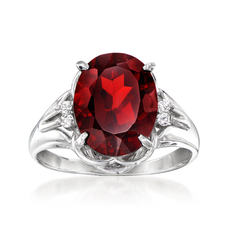 Red garnet cocktail ring with clear diamond accents and oval center stone