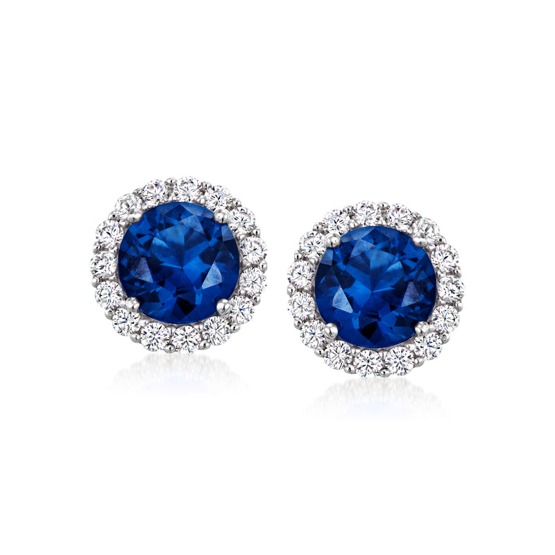 Sterling silver stud earrings with oval blue simulated sapphire and clear CZ halo