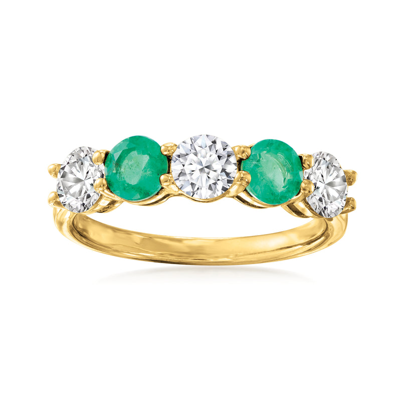 14kt yellow gold ring with center round diamond, emerald side stones, and diamond accents