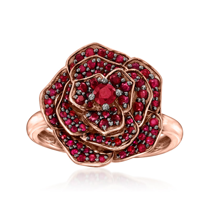 Rose gold ruby flower ring with oval center stone and red halo of gemstones