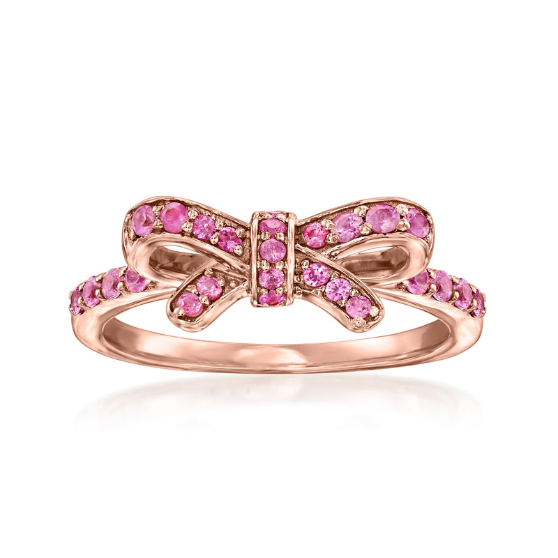 Pink sapphire bow ring with rose-gold setting and pink gemstone accents