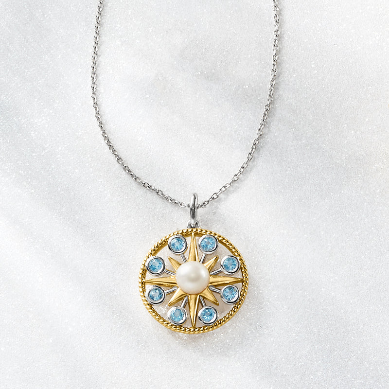 Gold-tone sun pendant necklace with white pearl and round sky-blue gemstones on chain