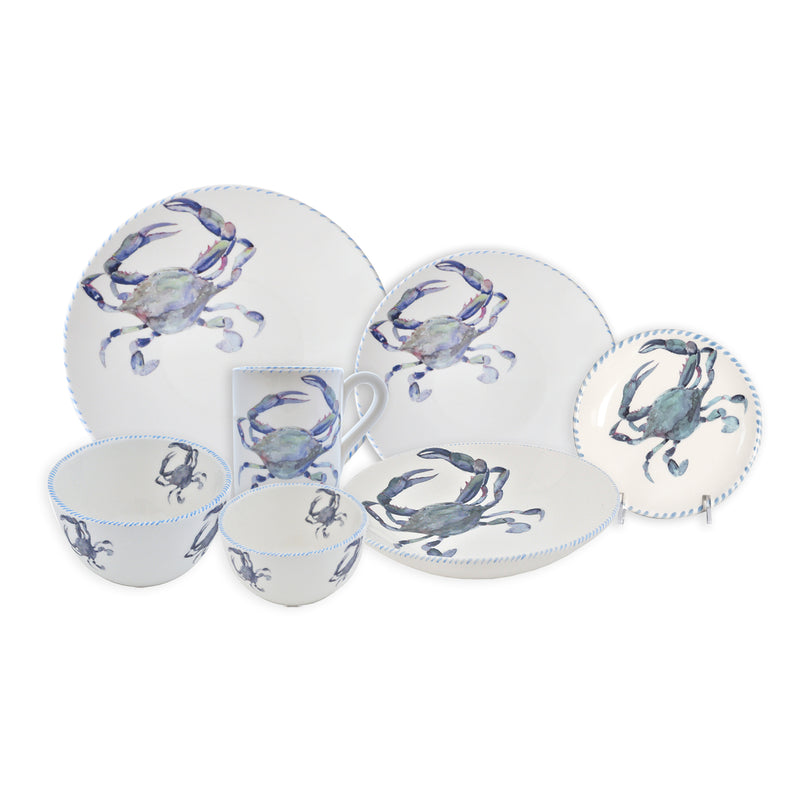 Ceramic dinnerware set with blue crab motif: plates, bowls, and small cups