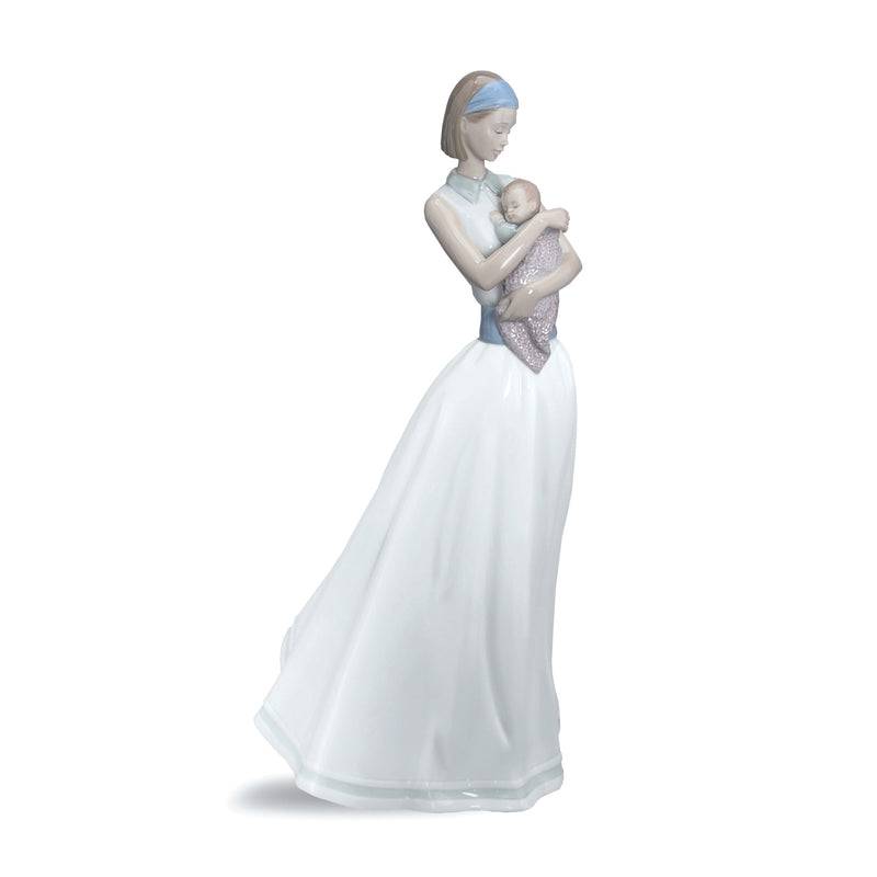 Porcelain figurine of a woman holding a baby, white gown with a blue headpiece