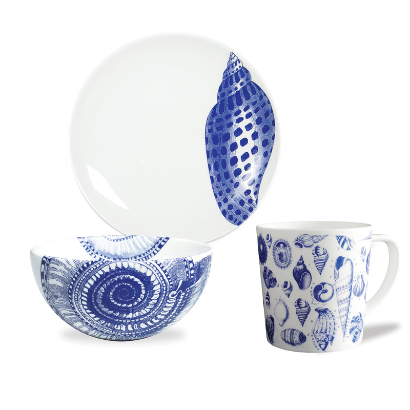 Blue-and-white porcelain dinnerware set with shell pattern: mug, bowl, and plate.