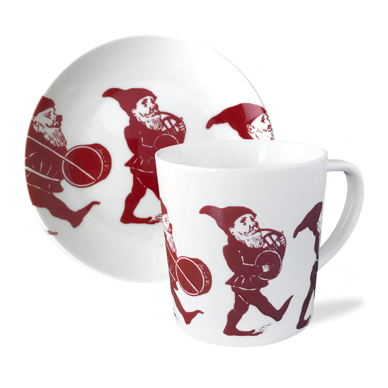 Red and white porcelain mug with Santa-and-elf print, paired with matching plate