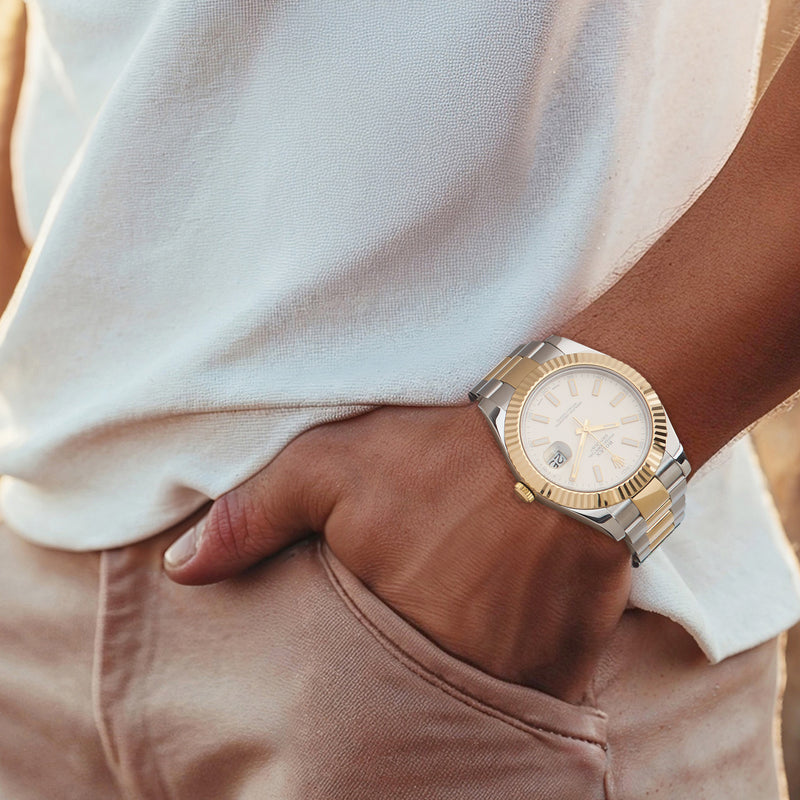 Men's stainless steel & yellow gold Rolex watch on wrist, champagne dial with date
