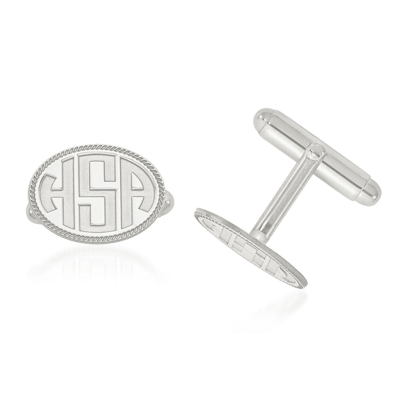 Oval white gold cuff links with recessed monogram letters and engraved border