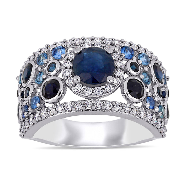 White gold sapphire and diamond cluster ring with oval blue center and round diamond accents