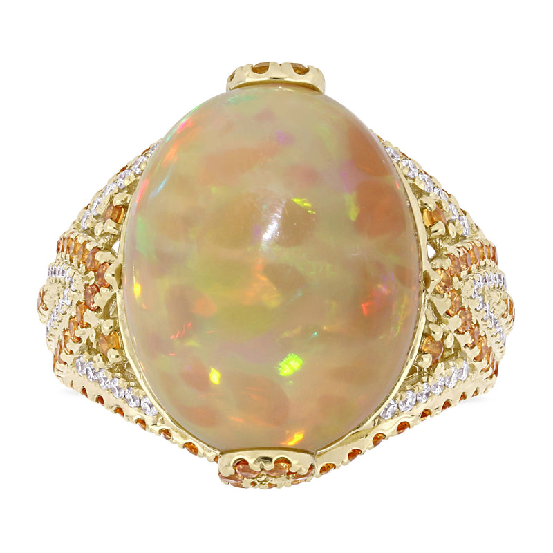 Oval opal cabochon cocktail ring in 14kt yellow gold with diamond halo and side stones