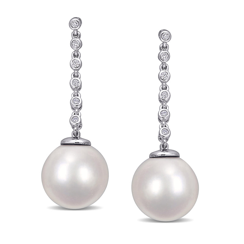 White gold drop earrings with large round white pearl and diamond-like accent halos
