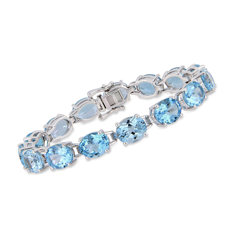 Sterling silver tennis bracelet with light blue oval topaz stones and box clasp
