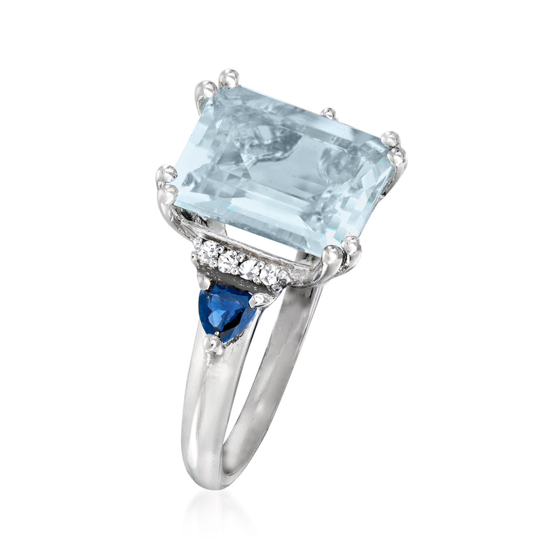 Sterling silver ring with rectangular aquamarine center, side blue sapphires, and diamond detailing