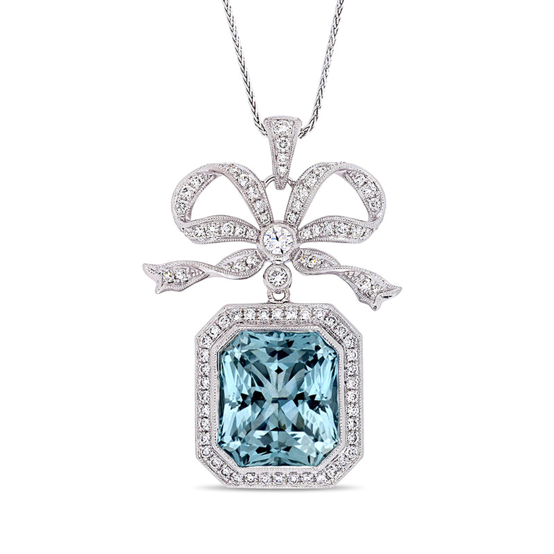 14kt white gold pendant necklace with blue topaz center and diamond halo bow