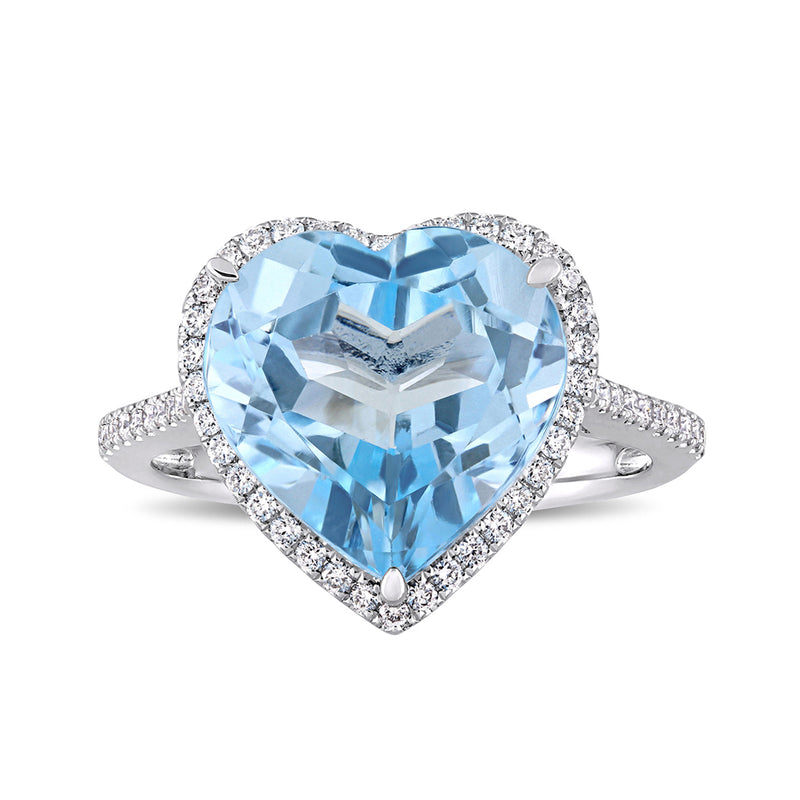 Heart-shaped sky blue topaz ring in 14kt white gold with diamond halo and band