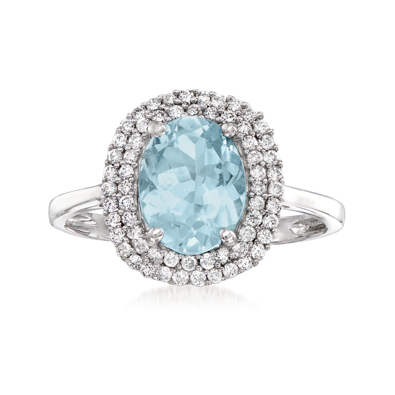 Aquamarine oval halo ring in 14kt white gold with round diamond surround