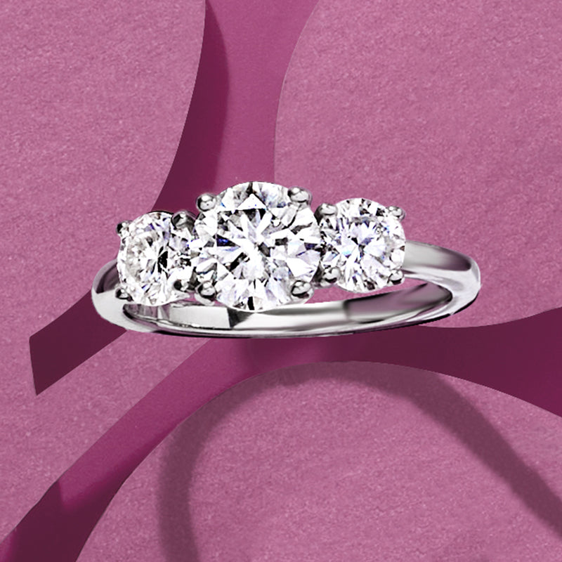 Three-stone moissanite ring in sterling silver with large center round stone