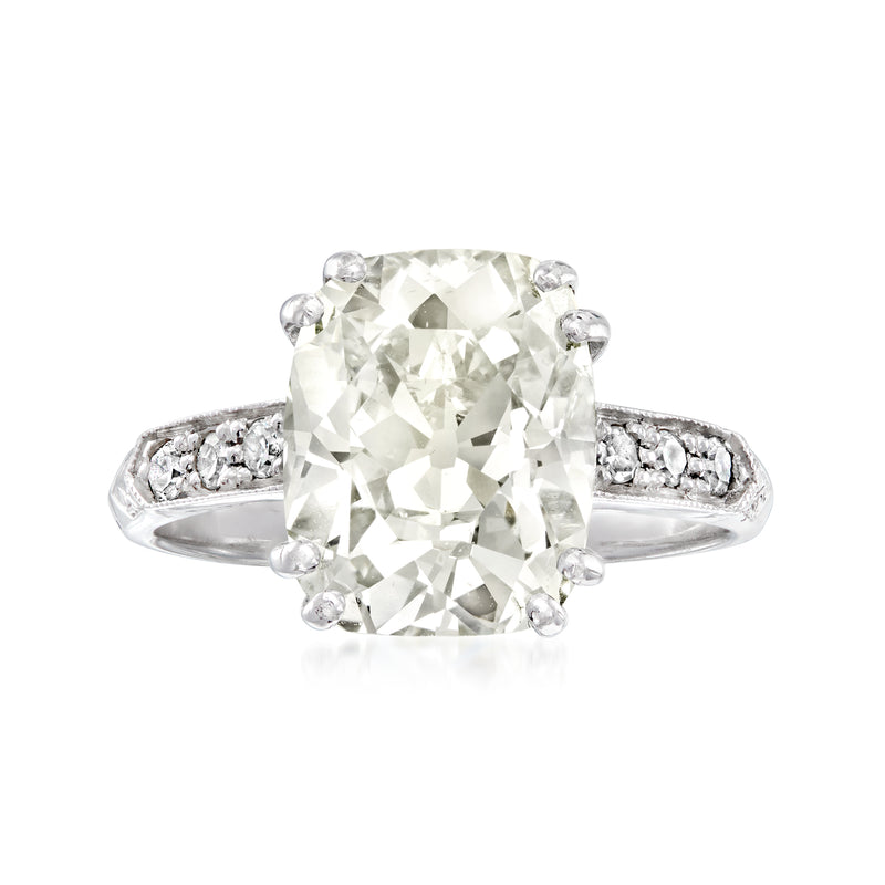 Vintage platinum diamond ring with cushion-cut center stone and pavé band