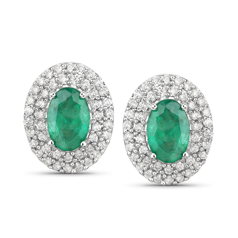 Oval emerald-green stone haloed by white diamonds in 14kt white gold stud earrings