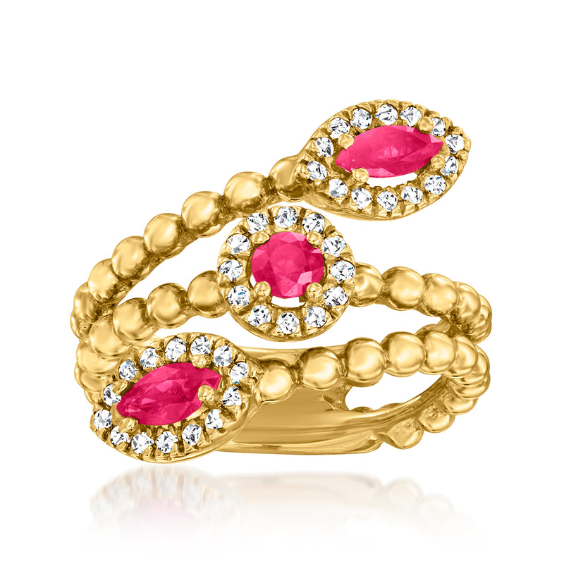 14kt yellow gold bypass ring with pink ruby and round diamond halo details